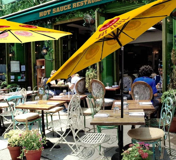Custom market umbrella used at a café with branded canopy design.